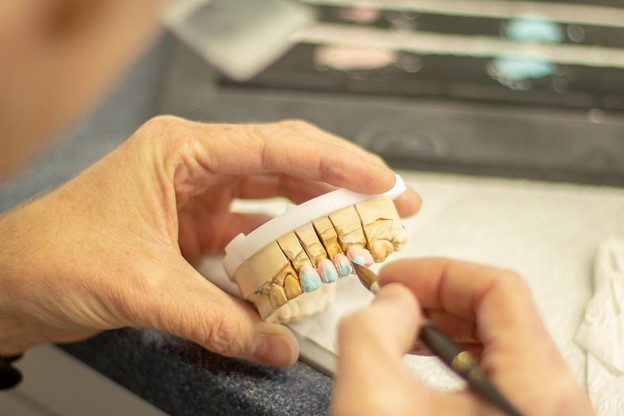 Periodontist creating dental implant as part of overall orthodontic care