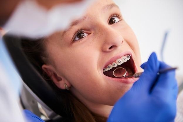 Young girl with braces getting early orthodontics