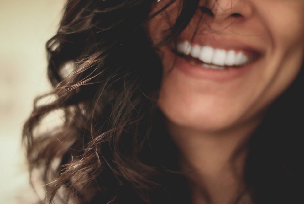 a close up image of a woman smiling