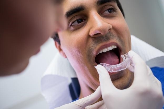 Man having Invisalign fit by orthodontist